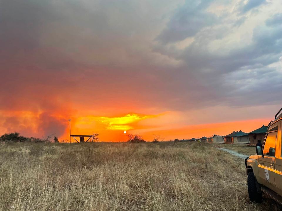 Our safari vehicle parked at sunset